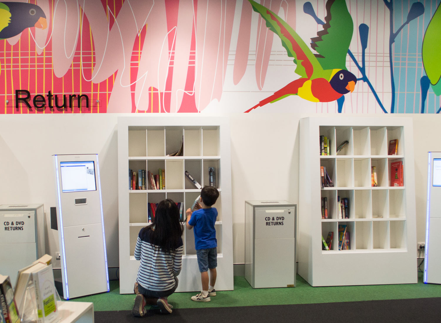 Mother and son browsing smartshelf in Brisbane library