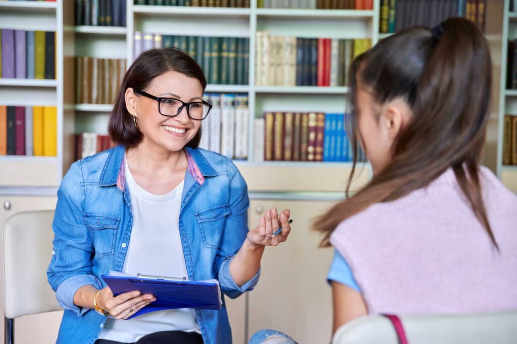 two ladies in a library having a conversation