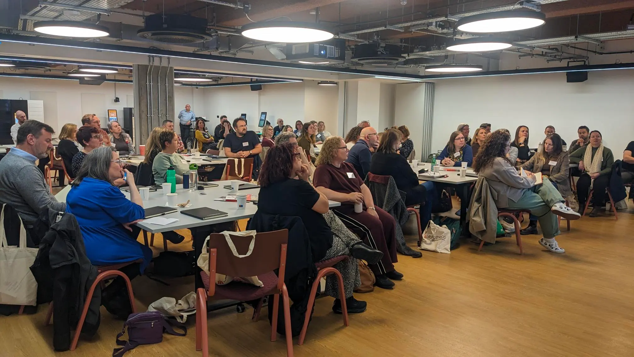 Library professionals attending the North Roadshow at The Stockroom, engaged in presentations and networking during the Bibliotheca event.