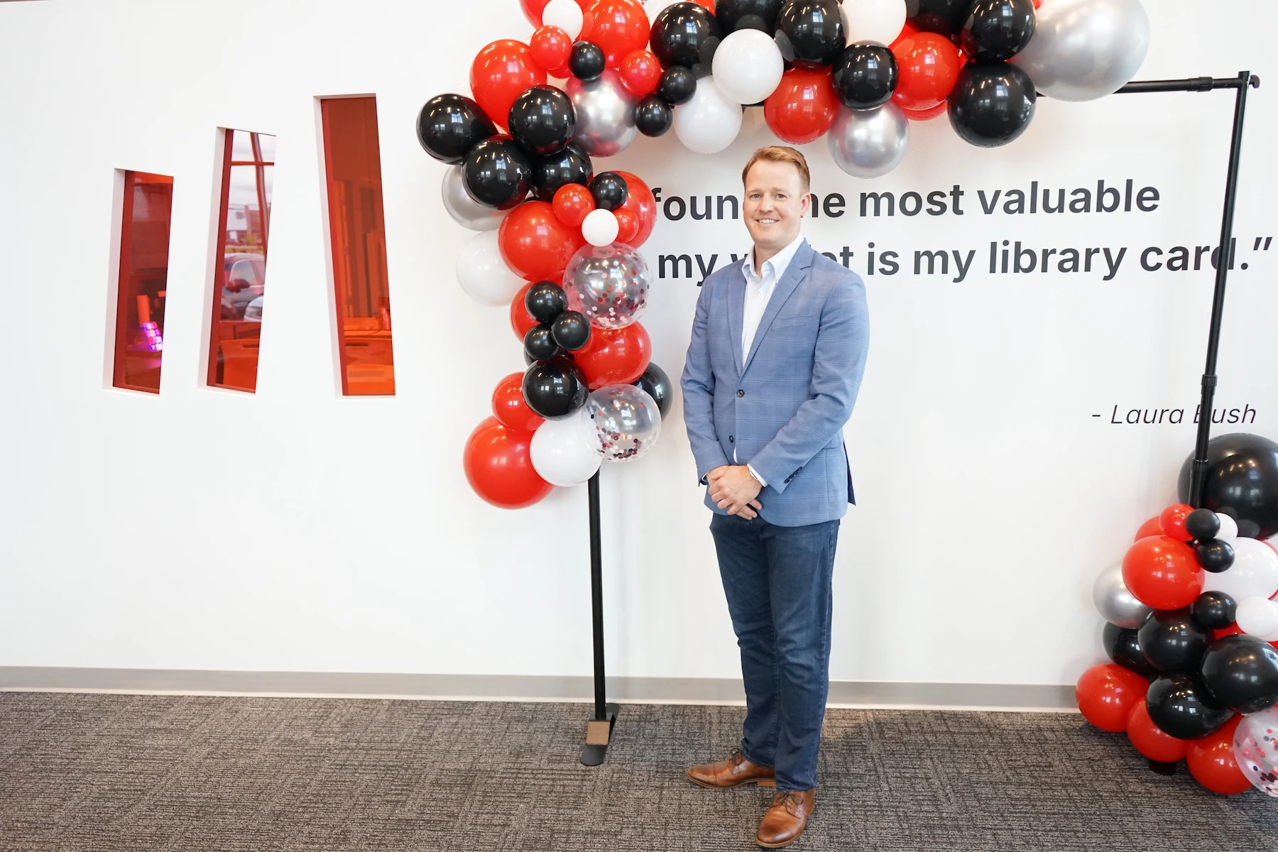 Matthew Bellamy poses by a balloon display during his welcome event as new CEO of Bibliotheca