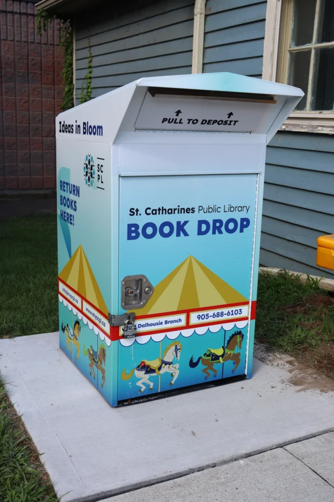 Colorful book drop at Port Dalhousie Branch of St. Catharines Public Library featuring carousel-themed artwork